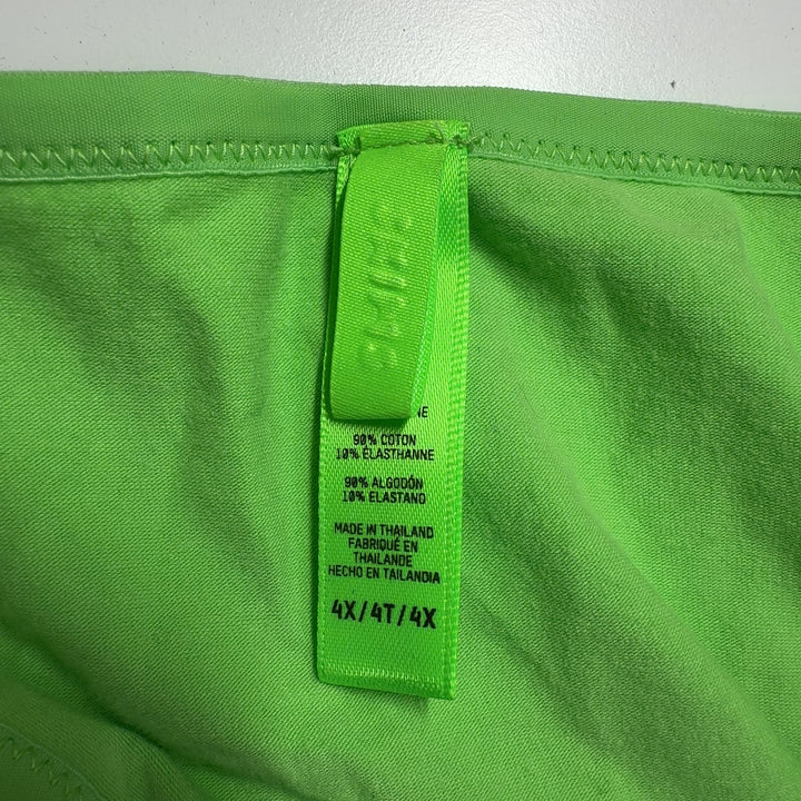 Tag view of woman wearing green cropped t-shirt by Skims with black fitted leggings