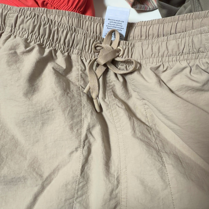 Beige DSG athletic shorts back view, showing relaxed fit and functional pockets