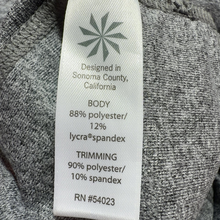 Tag view of gray polyester Athleta bike shorts showing fit and design details