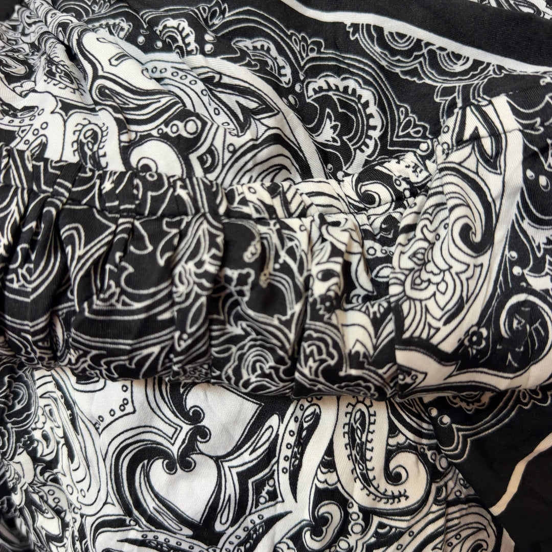 Black and white ornamental halter dress with paisley pattern and adjustable halter straps, back view