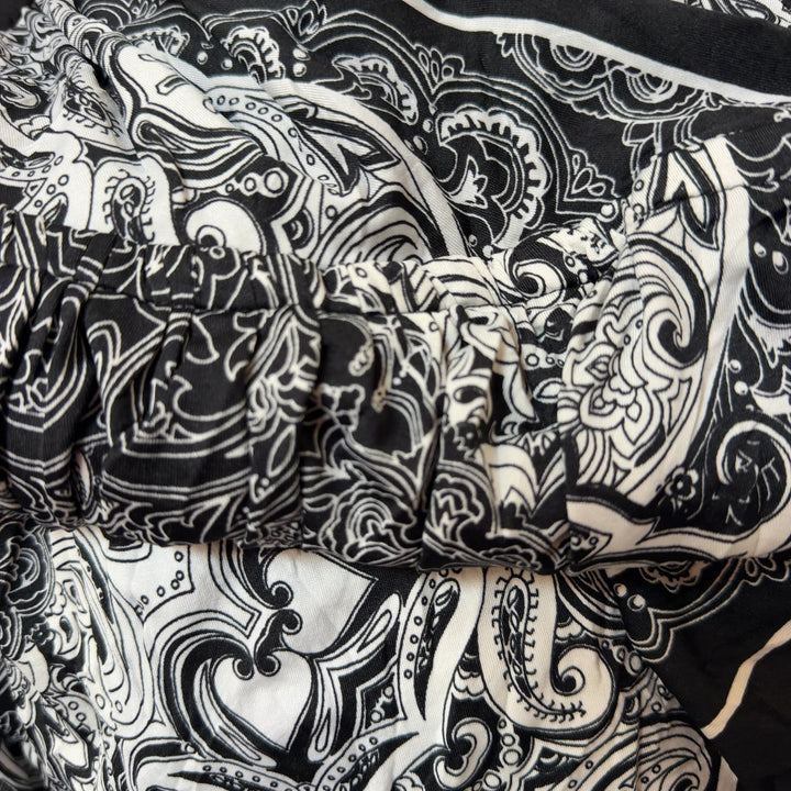 Black and white ornamental halter dress with paisley pattern and adjustable halter straps, back view