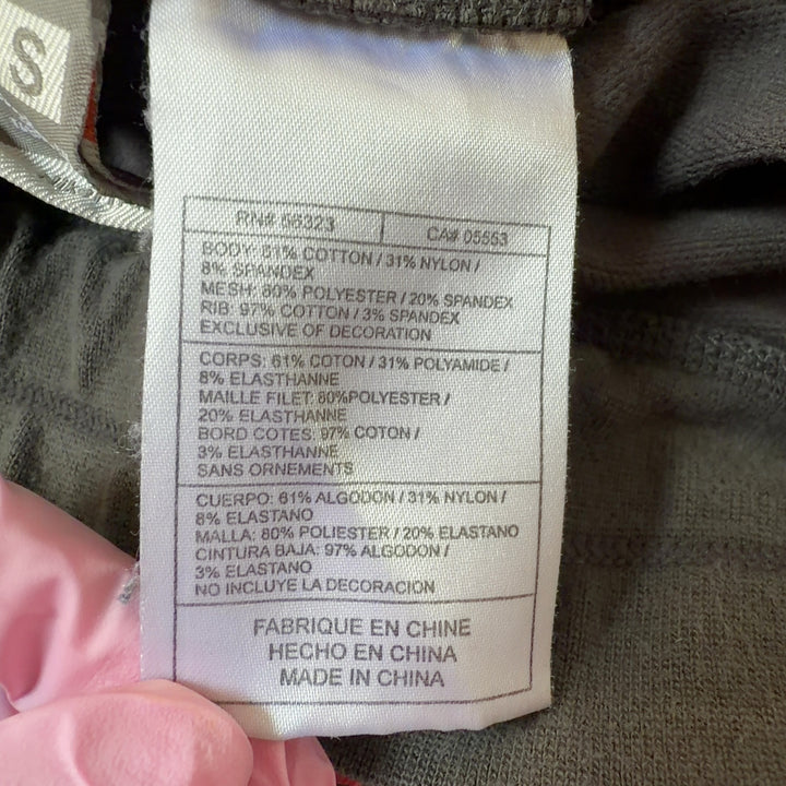 Tag view of gray and pink Nike athletic shorts showing side pink accents and athletic fit