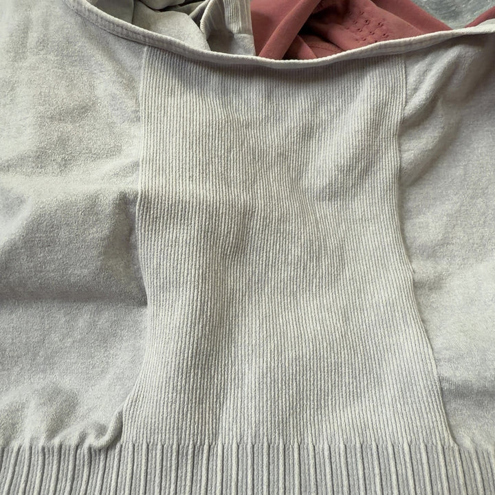 Tag view of cream ribbed tank all-in-one jumpsuit showing fitted silhouette and high-waisted design