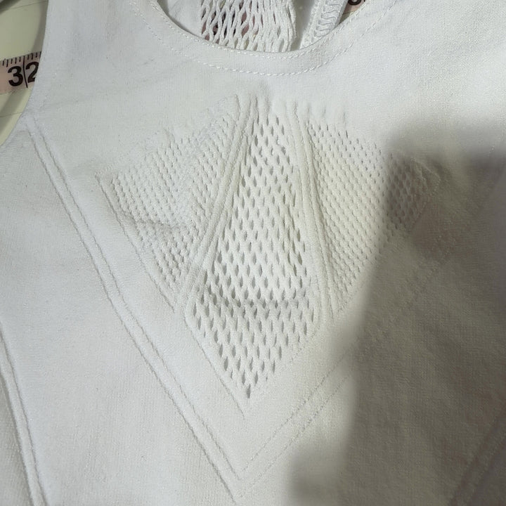 White mesh cutout sports bra with racerback design, back view on model