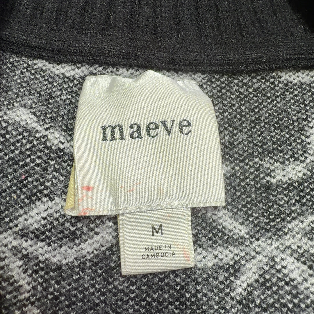 Tag view of black bow print pullover knit showing cropped silhouette and voluminous sleeves