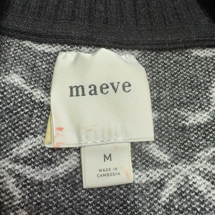 Tag view of black bow print pullover knit showing cropped silhouette and voluminous sleeves