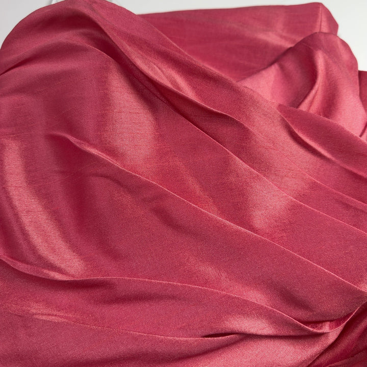 Tag view of pink strapless cocktail dress showing elegant draping and knee-length hem