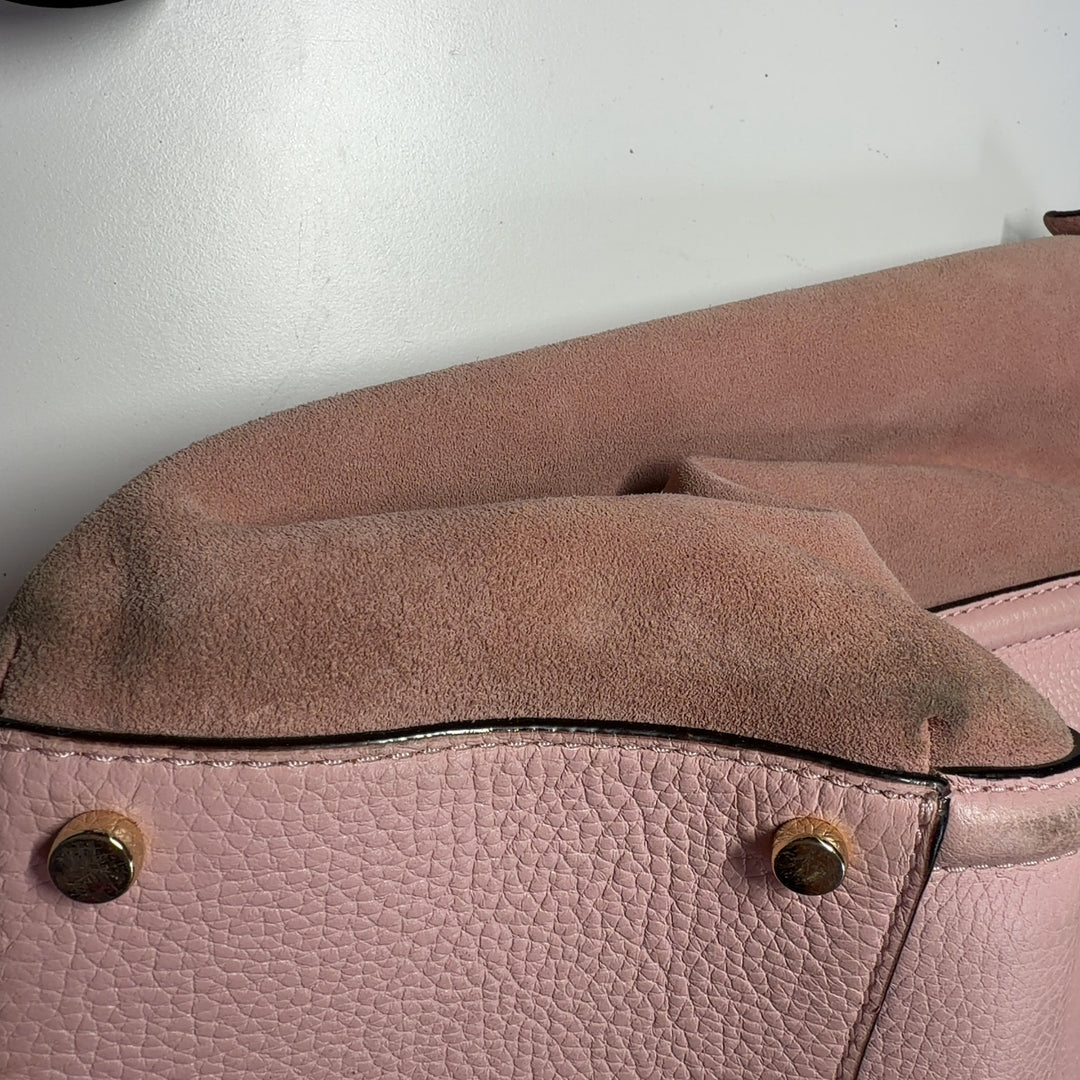 Blush pink leather Kate Spade tote bag worn on shoulder, back view