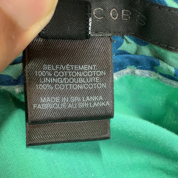 Tag view of Marc Jacobs teal floral A-line cotton skirt displaying elegant drape and botanical pattern