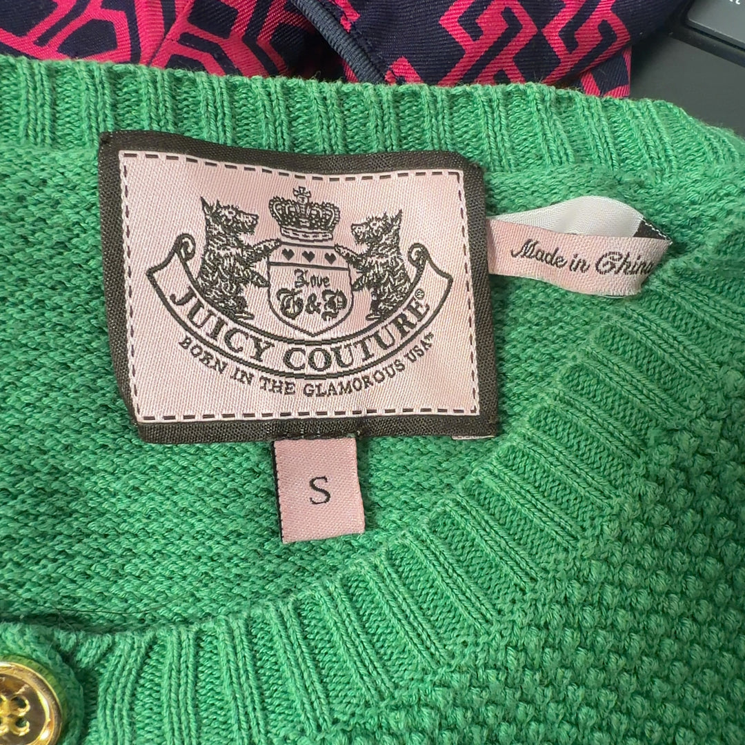 Tag view of green Juicy Couture knit cardigan showing button-up closure and fitted silhouette
