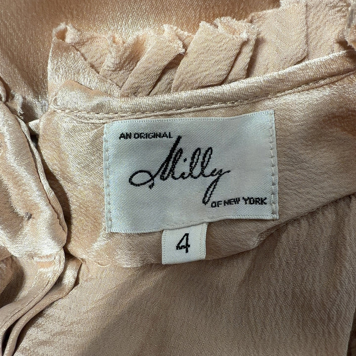 Cream sleeveless blouse with ruffled neckline by Milly, back view