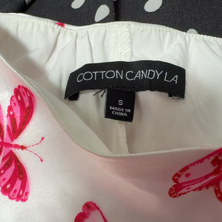 Cream butterfly print mini skirt back view, showing A-line silhouette and full butterfly pattern