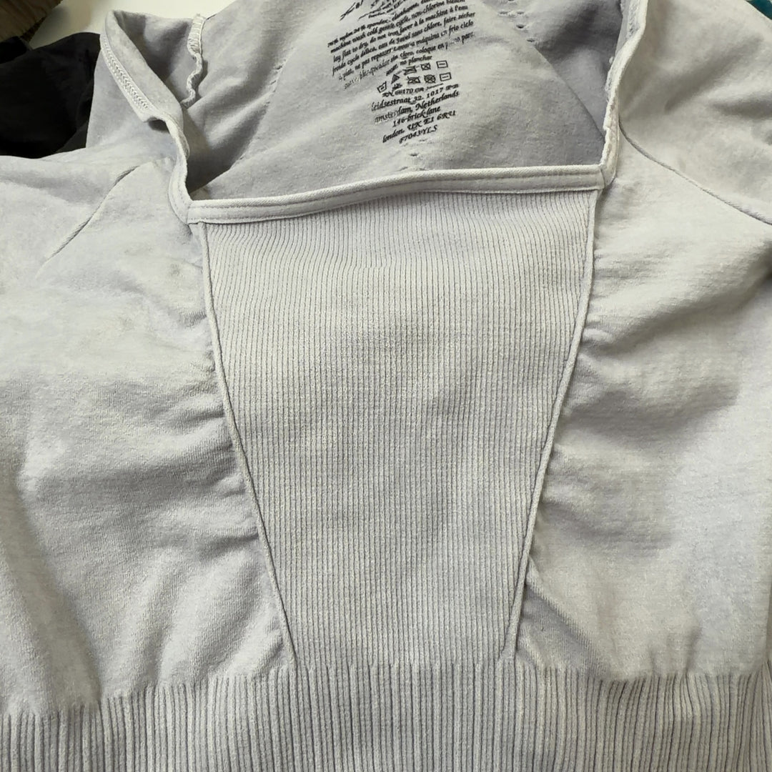 Tag view of cream ribbed all-in-one jumpsuit showing seamless construction and cropped ankle length