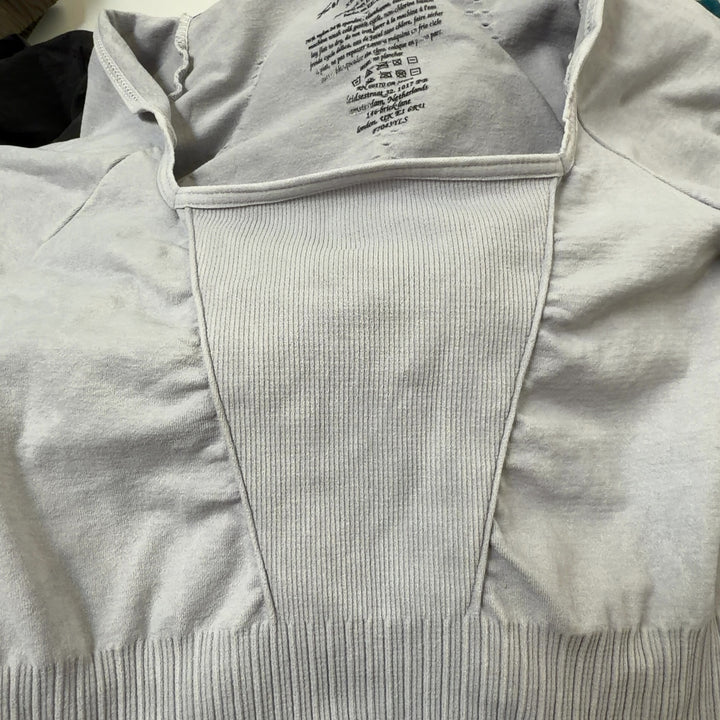 Tag view of cream ribbed all-in-one jumpsuit showing seamless construction and cropped ankle length
