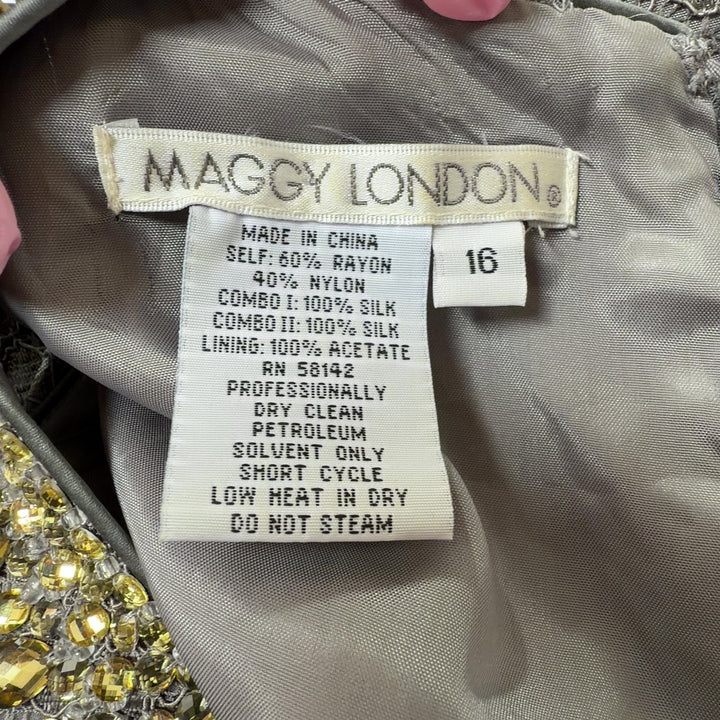 Tag view of gray lace cocktail dress showing sleeveless silhouette and textured lace pattern