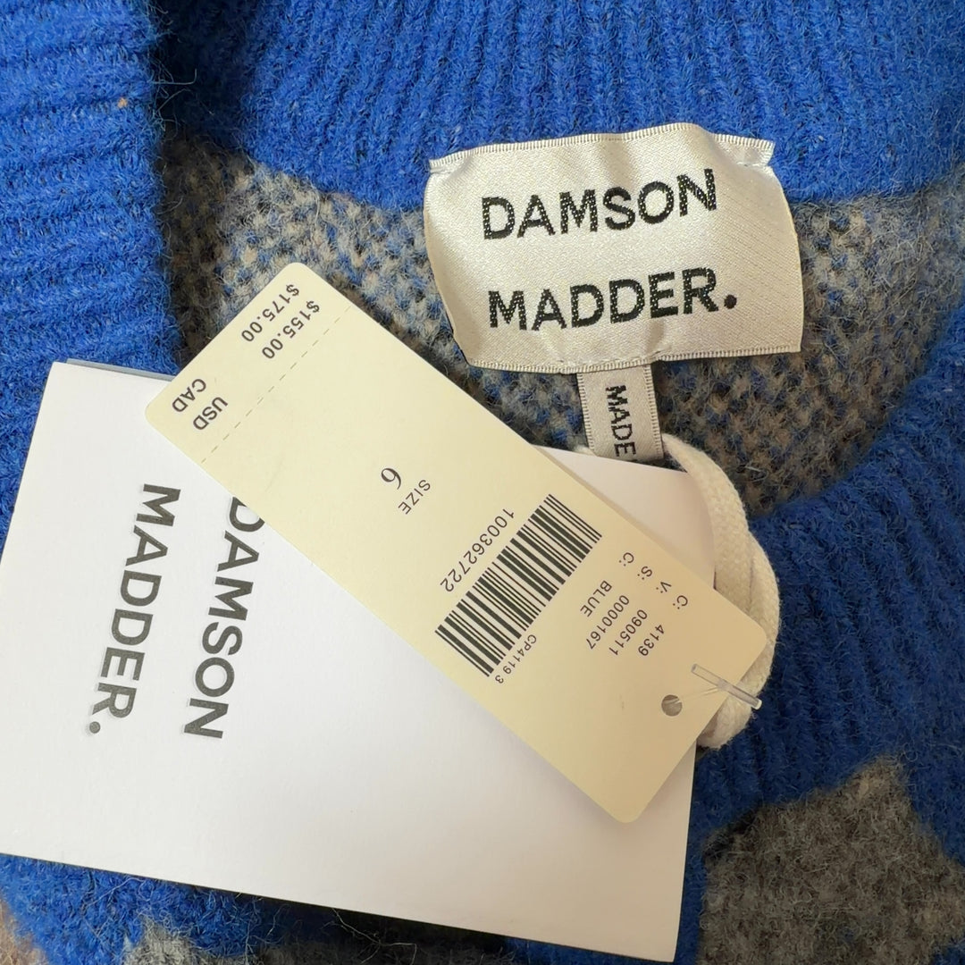 Tag view of blue argyle knit vest showing full argyle pattern design and sleeveless cut