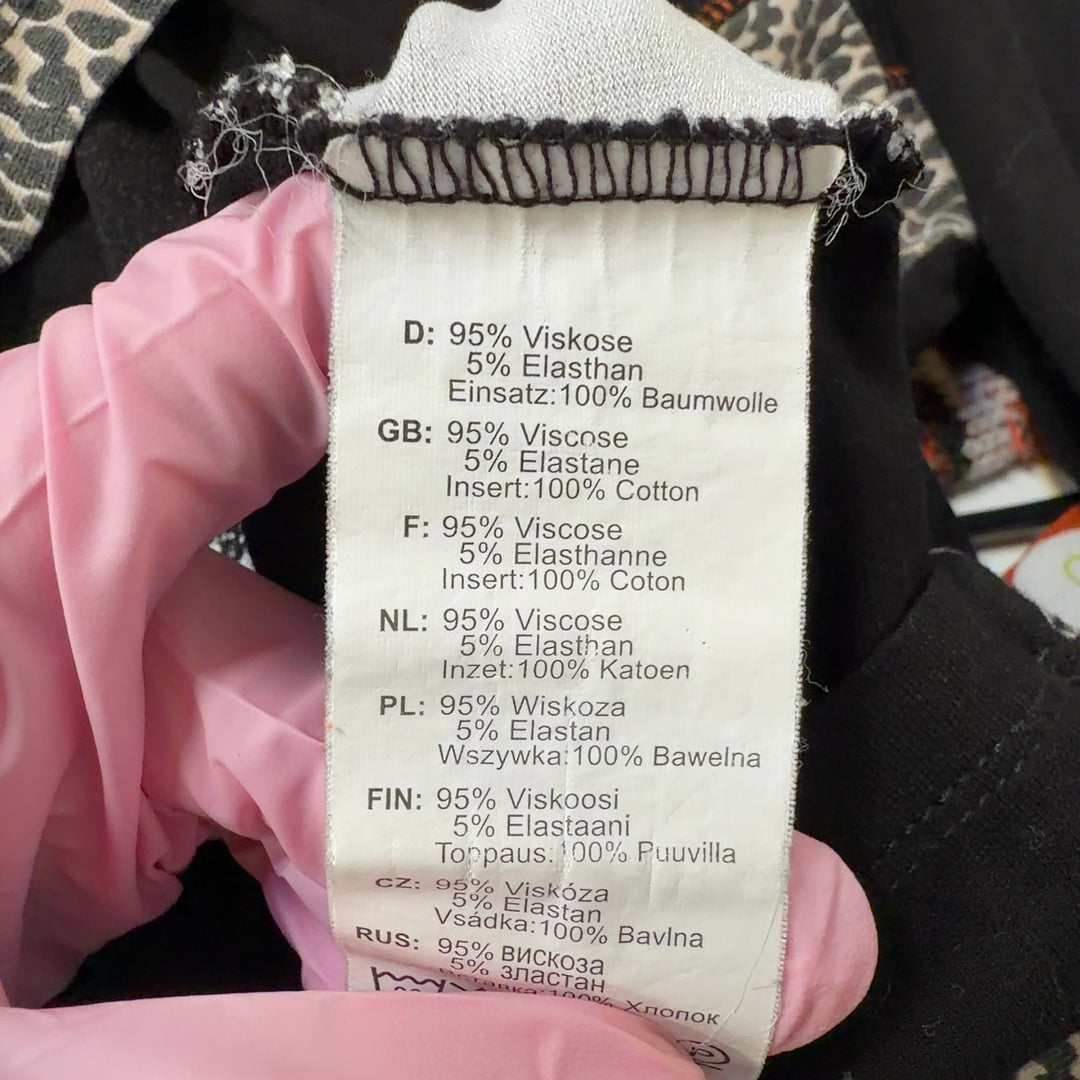Tag view of black mixed pattern long sleeve top showing leopard print side panels and patchwork design