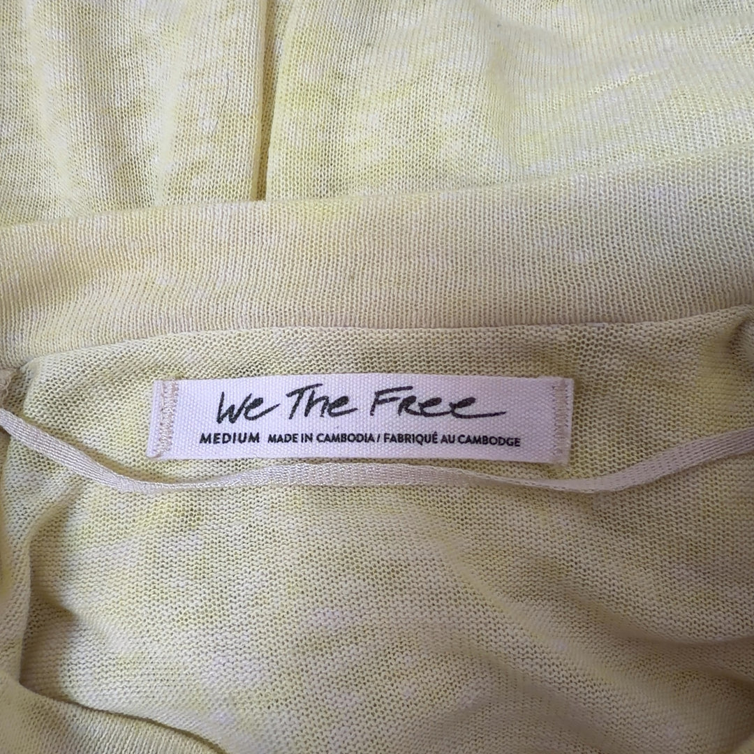 WE THE FREE yellow pocket knit t-shirt back view, oversized casual tee paired with black leggings