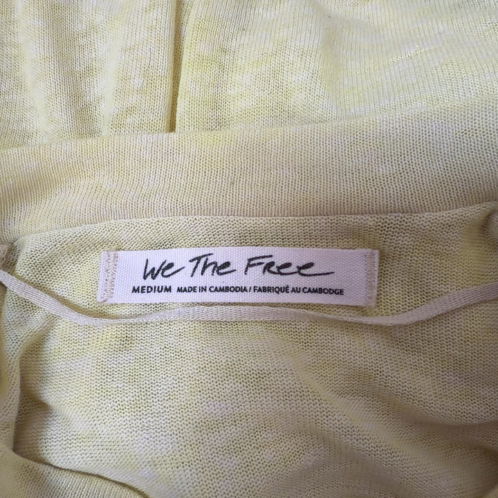 WE THE FREE yellow pocket knit t-shirt back view, oversized casual tee paired with black leggings