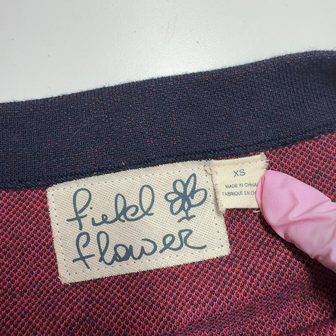 Navy knit dress with pink floral pattern, back view showing artistic botanical motif design