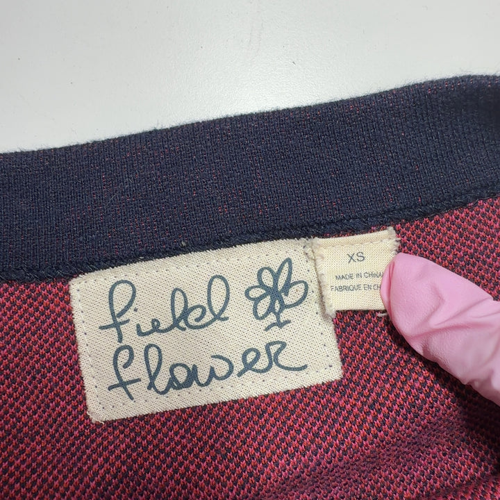 Navy knit dress with pink floral pattern, back view showing artistic botanical motif design