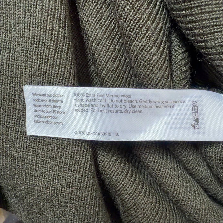 Olive green merino wool turtleneck sweater back view showing relaxed tunic length silhouette