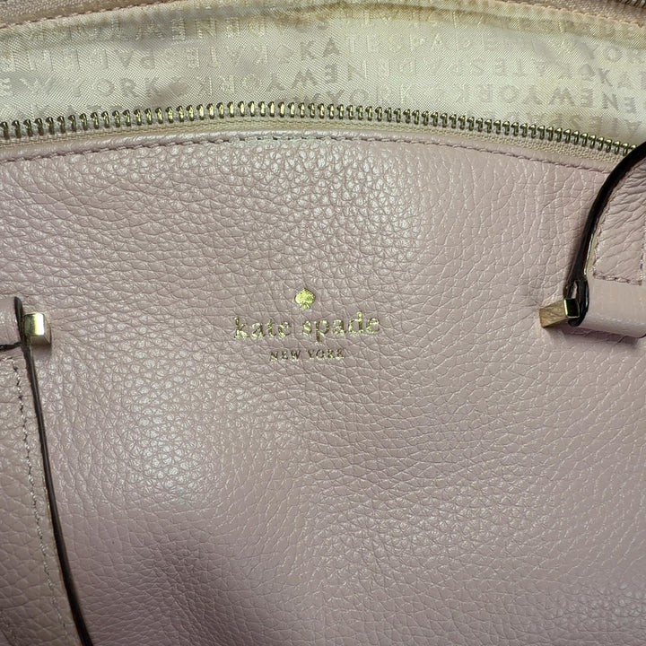 Blush pink leather Kate Spade tote bag worn on shoulder, back view