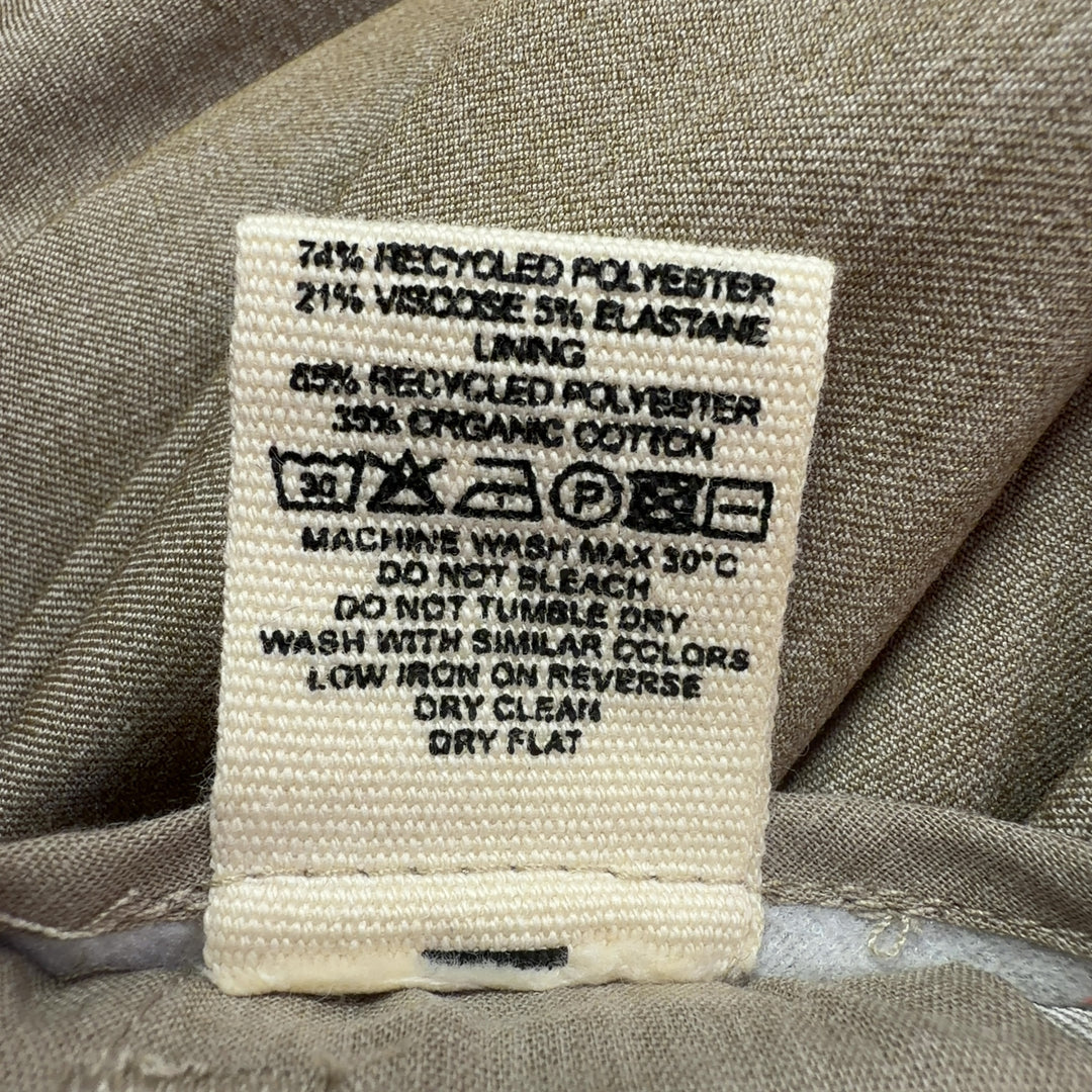 Tag view of beige paperbag waist trousers showing structured waistband and flattering silhouette