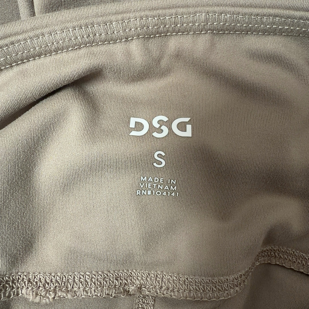 Woman wearing beige high-waist capri leggings with side pockets, back view showing fitted silhouette