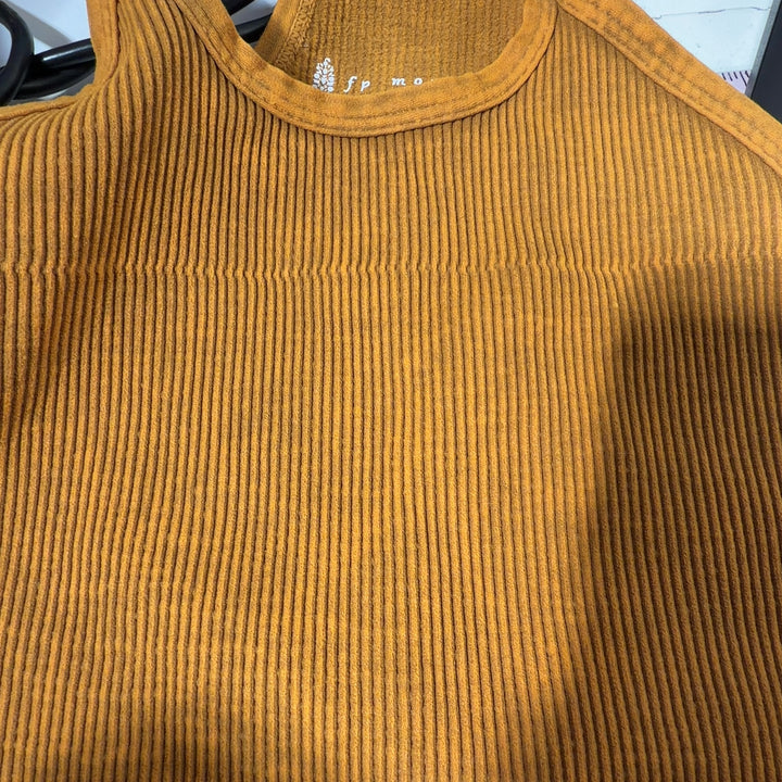 Gold ribbed crop tank top with spaghetti straps, back view on model