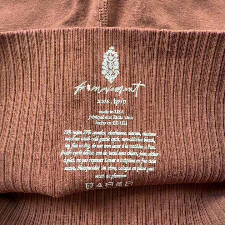 Rust ribbed high-waist activewear shorts back view, displaying high-waist cut and sleek design