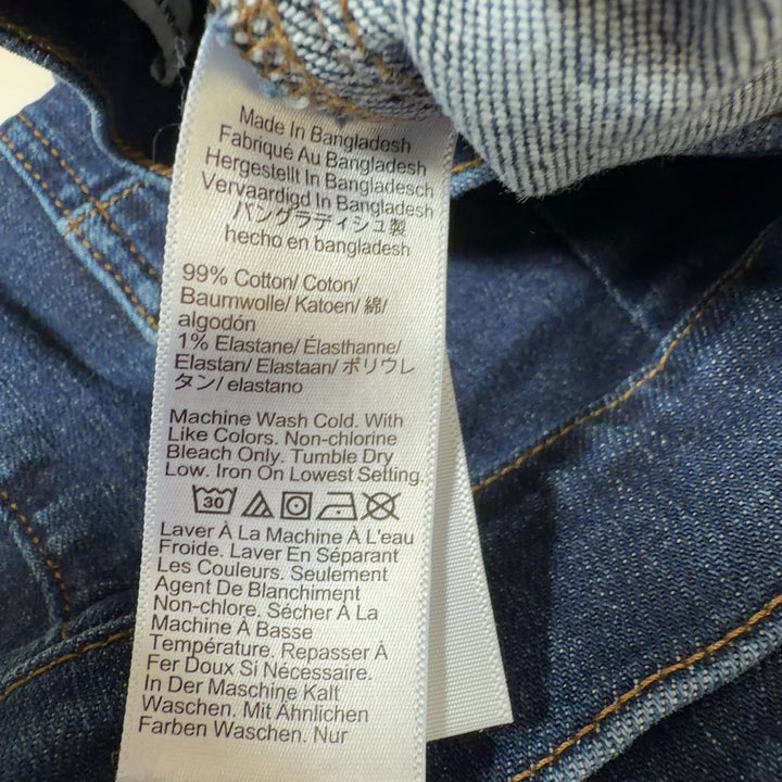 Tag view of dark blue wide-leg J.Crew jeans showing cropped ankle length and classic five-pocket design