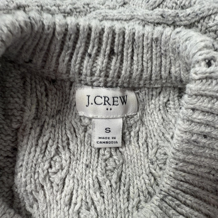 Tag view of cream cable knit pullover sweater showing textured diamond knit pattern and cropped silhouette