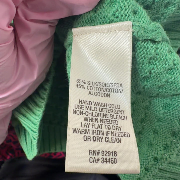 Tag view of green Juicy Couture knit cardigan showing button-up closure and fitted silhouette