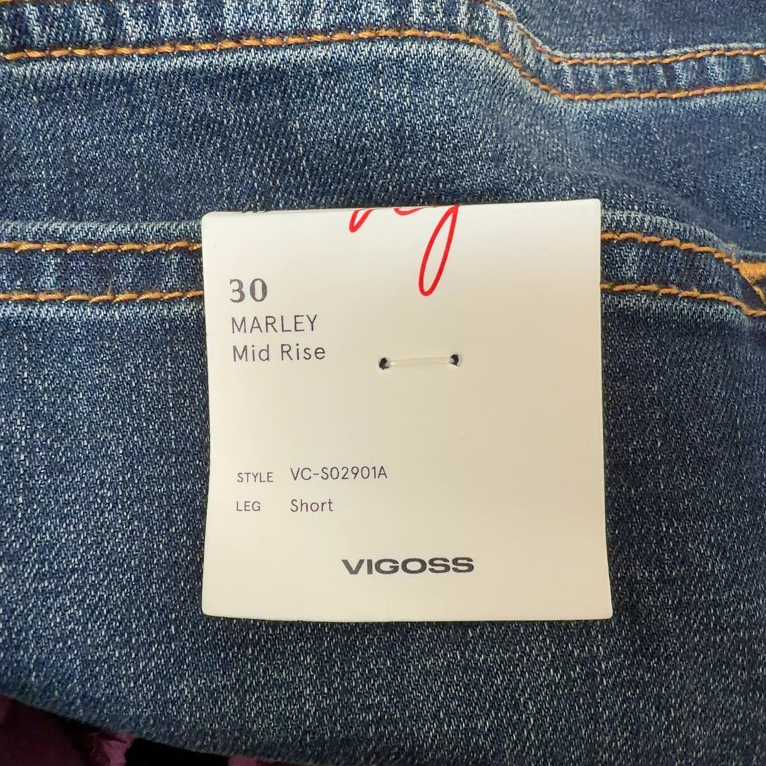 Dark blue denim cut-off shorts with distressed hem, back view