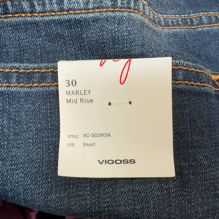 Dark blue denim cut-off shorts with distressed hem, back view