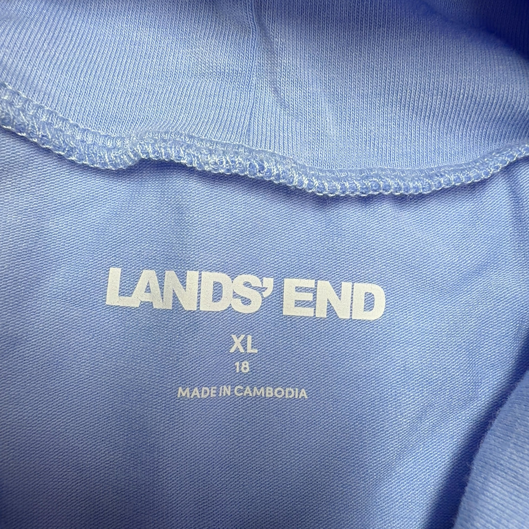 Light blue turtleneck long sleeve top from Lands' End, back view on model wearing black pants and yellow heels
