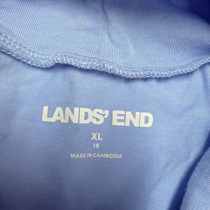 Light blue turtleneck long sleeve top from Lands' End, back view on model wearing black pants and yellow heels