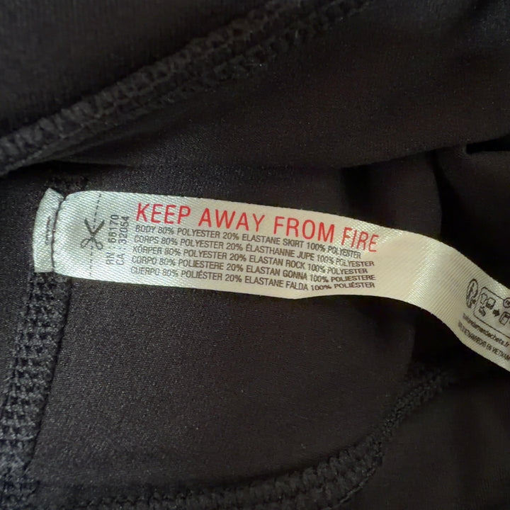 Black pleated athletic skirt with high waistband, back view showing pleated design
