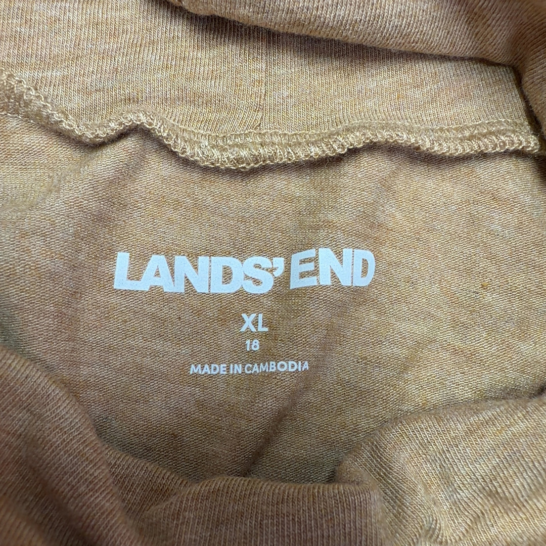 Tag view of camel turtleneck long sleeve top showing relaxed silhouette and length