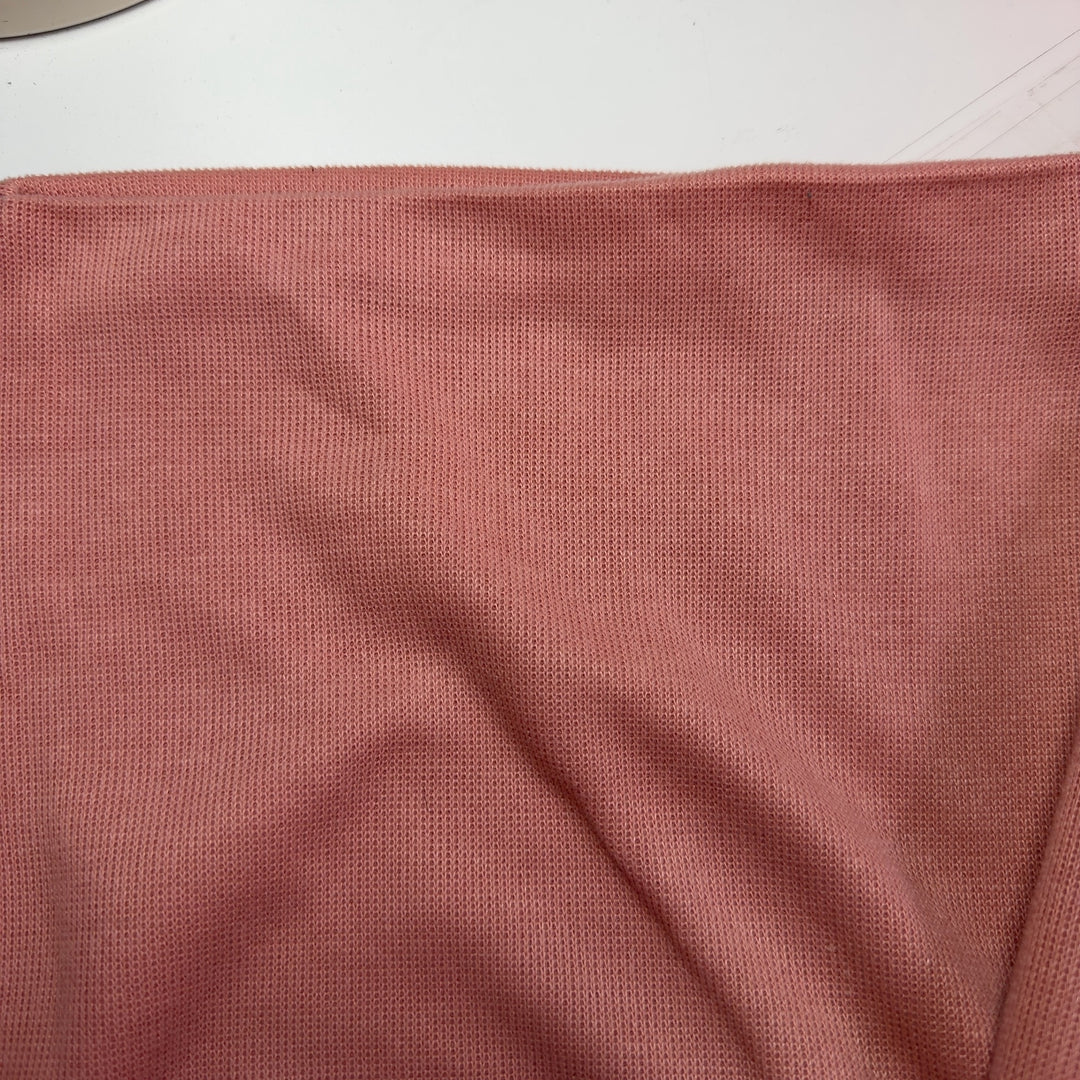 Peach cropped sweatshirt with black botanical embroidery, back view