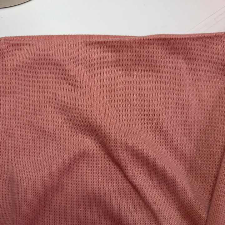 Peach cropped sweatshirt with black botanical embroidery, back view