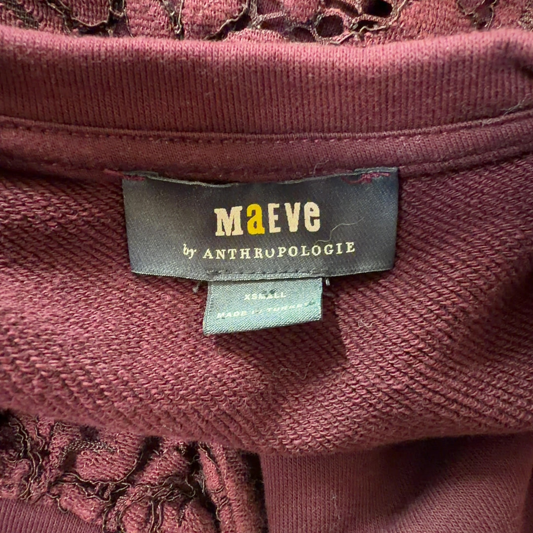 Tag view of burgundy lace cropped knit top showing lace sleeve detail and cropped silhouette