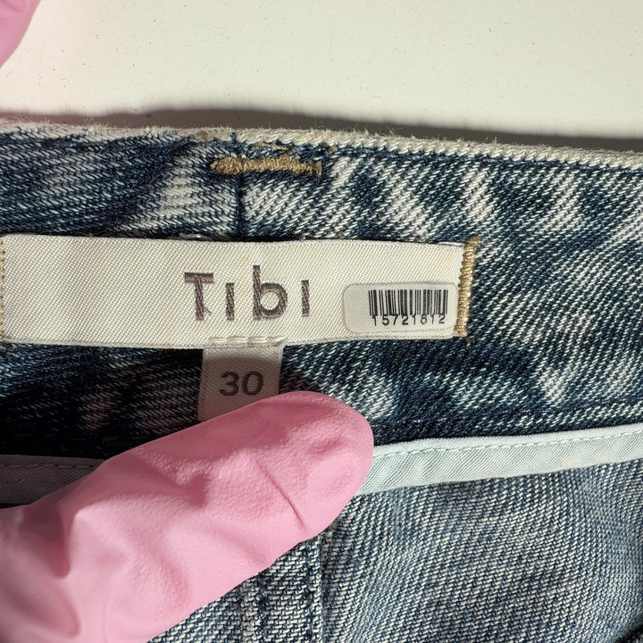 Side view of Tibi acid wash cropped jeans showing the relaxed fit and ankle-length cropped hem