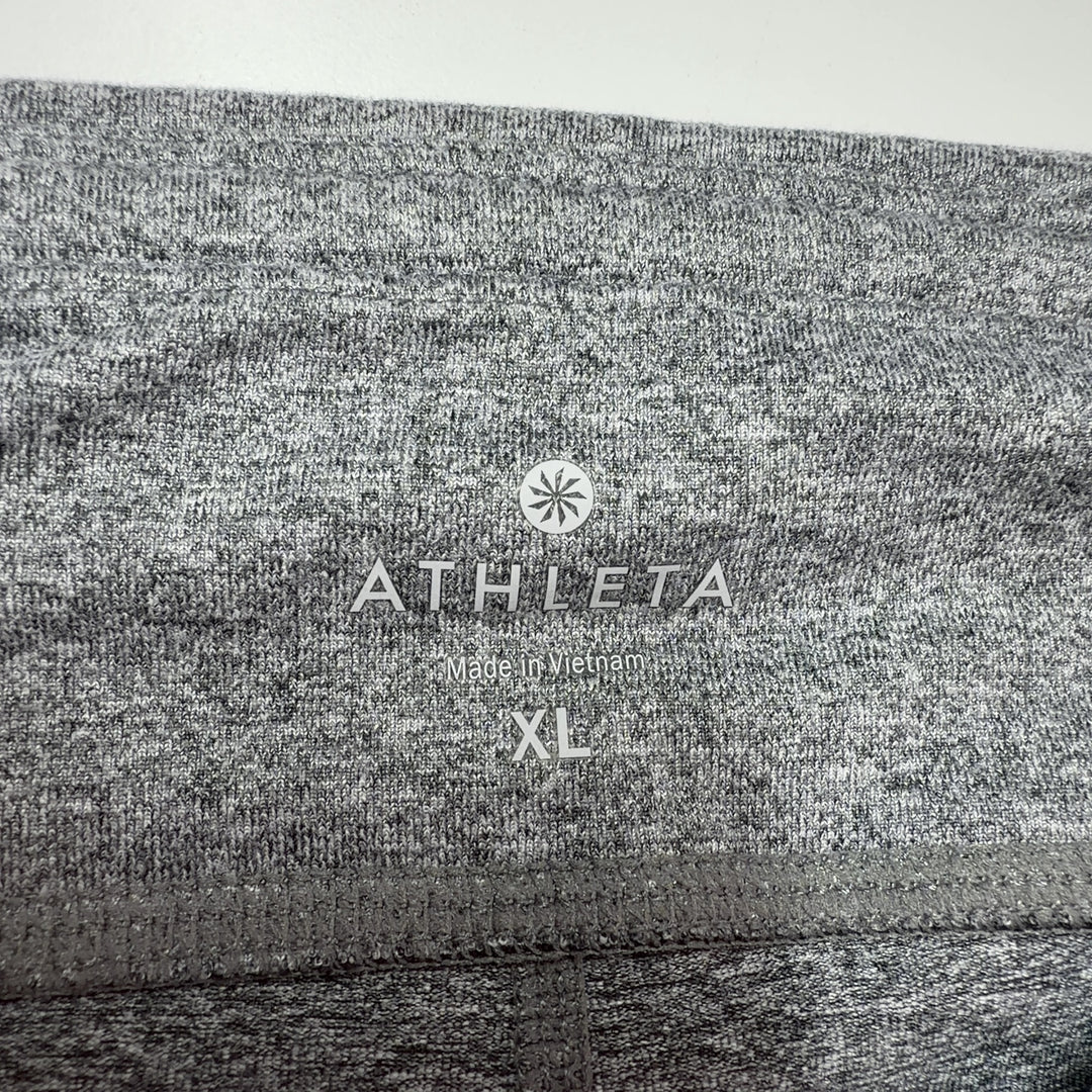 Tag view of gray polyester Athleta bike shorts showing fit and design details