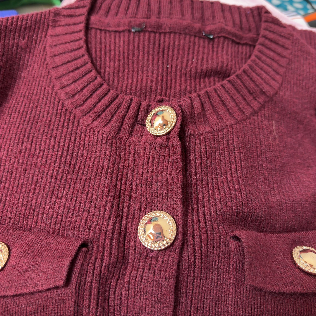 Burgundy ribbed knit cardigan back view showing button closure and cropped length
