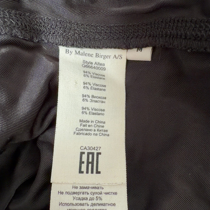 Black wrap midi skirt with tie detail and A-line silhouette by MB by Malene Birger, back view
