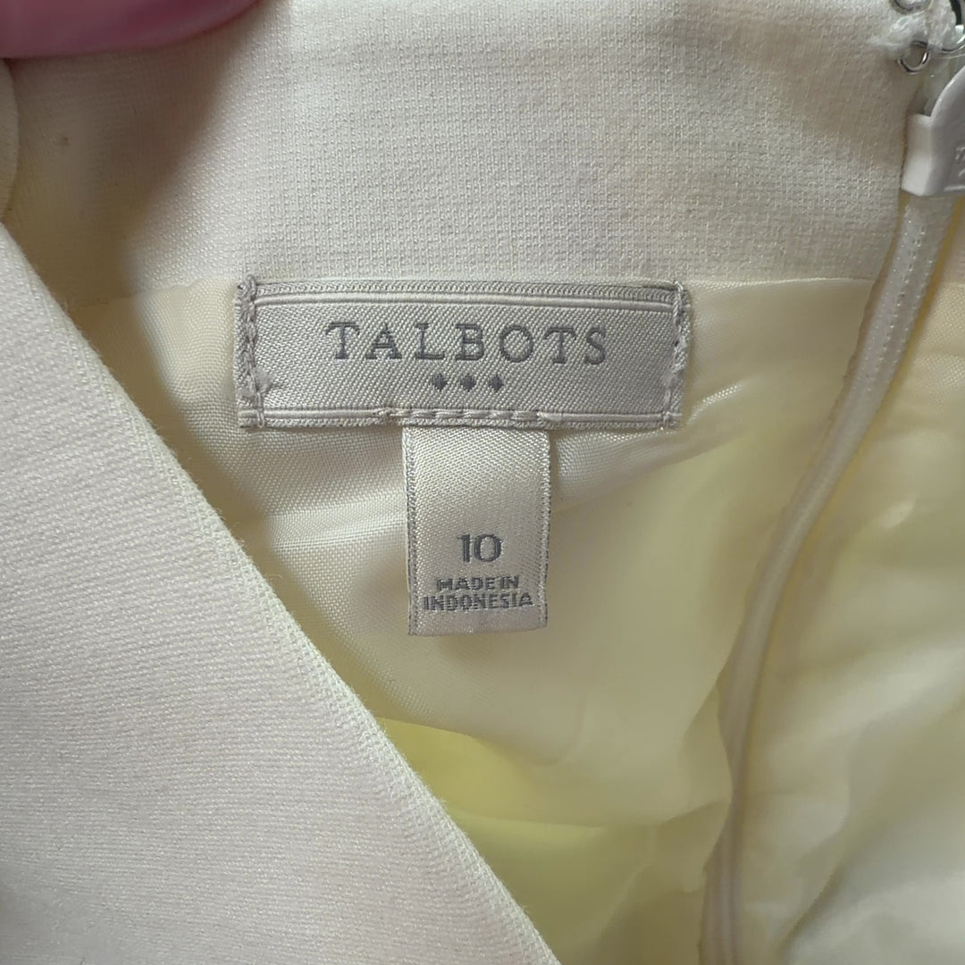 Tag view of cream and black colorblock sleeveless dress showing elegant silhouette and draping