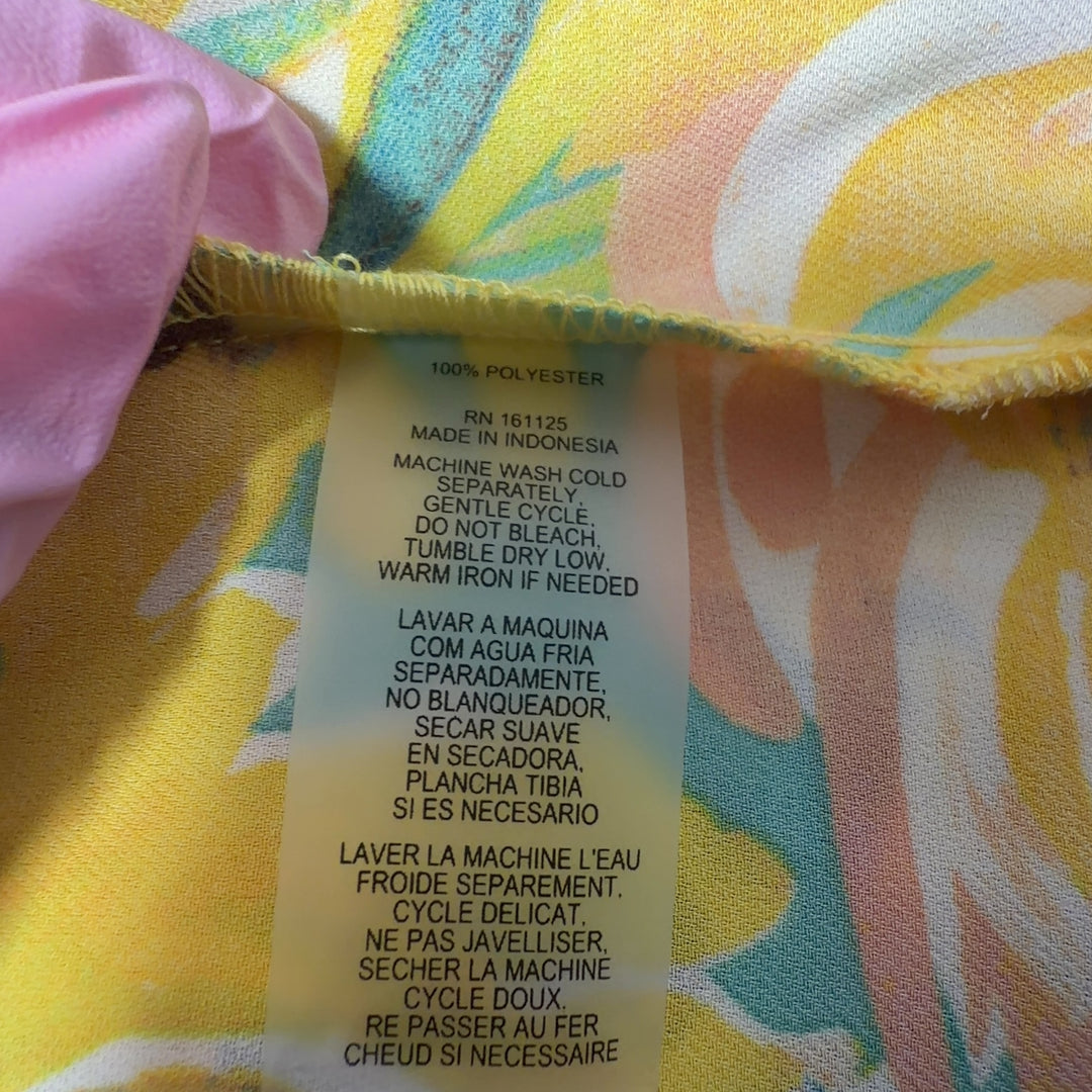 Tag view of yellow floral Sioni top showing pleated bell sleeves and relaxed fit silhouette