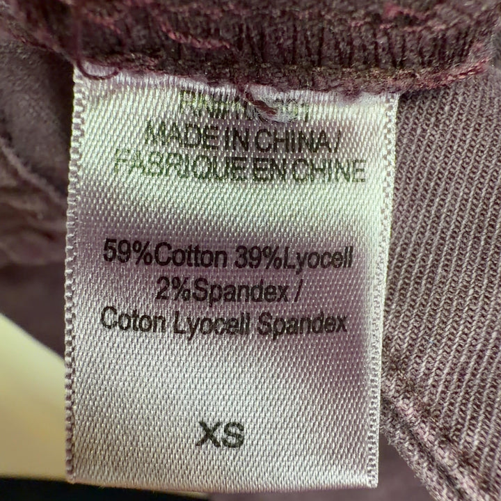 Tag view of burgundy wide-leg pants showing relaxed fit through hip and thigh, demonstrating the comfortable and stylish cut of Young Fabulous & Broke design